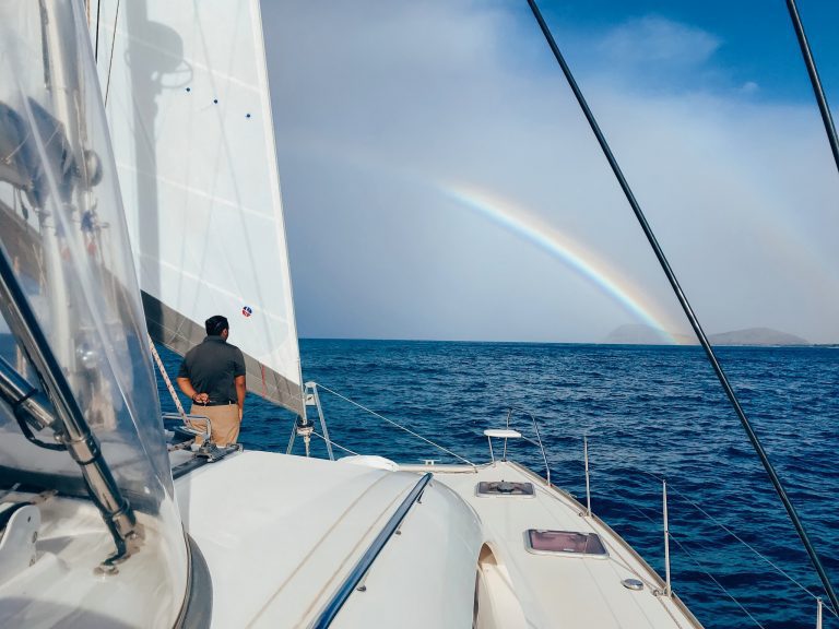 Crew Rodney with a beautiful rainbow off of Maili point on the Waianae Coastline on a MANA Cruises private charter sail