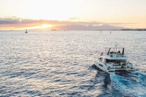 MANA Cruises' Waikiki vessel, The HILINA'I cruising into the sunset off of the coast of Waikiki right by Diamond Head